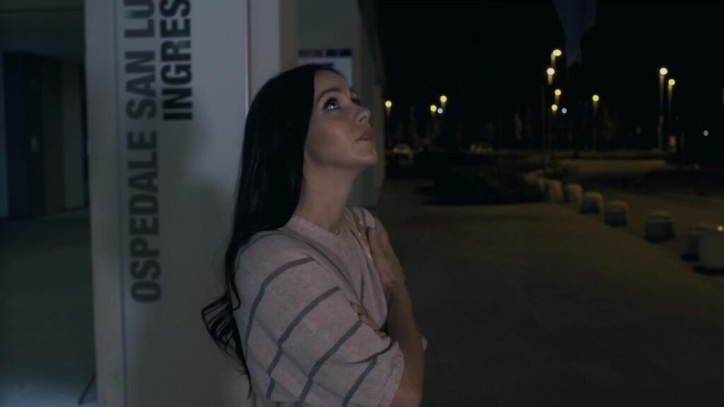 Photo of of a scene from the Italian movie "The Last Fighter" featuring Actress Shari Fontani looking at the night sky