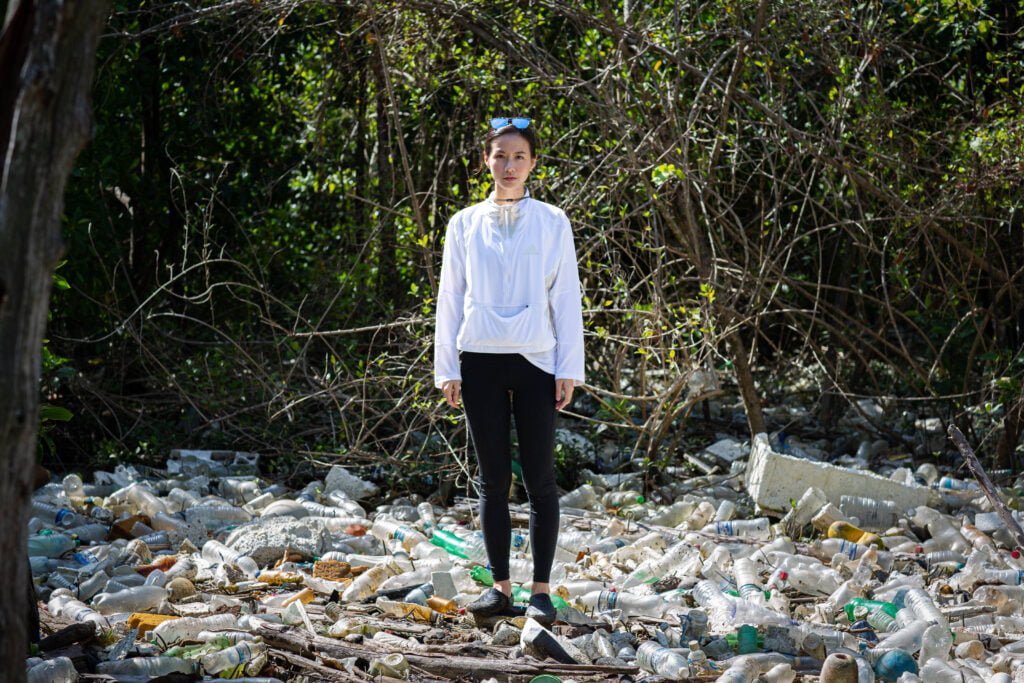 Photo of Melissa Tan at a Dumping site full of Plastic Waste