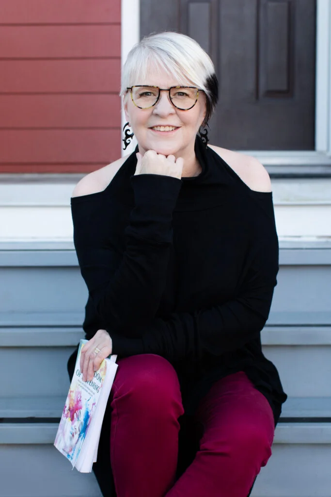 Photo of Fashion Editor, Marilyn R. Wilson holding her book "The Wisdom of Listening"