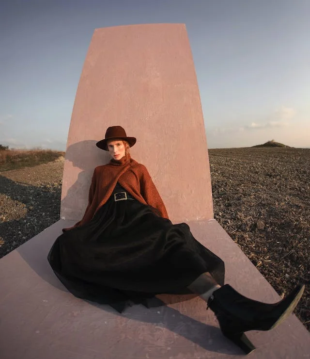 A sustainable fashion model posing with her outfit in the sun
